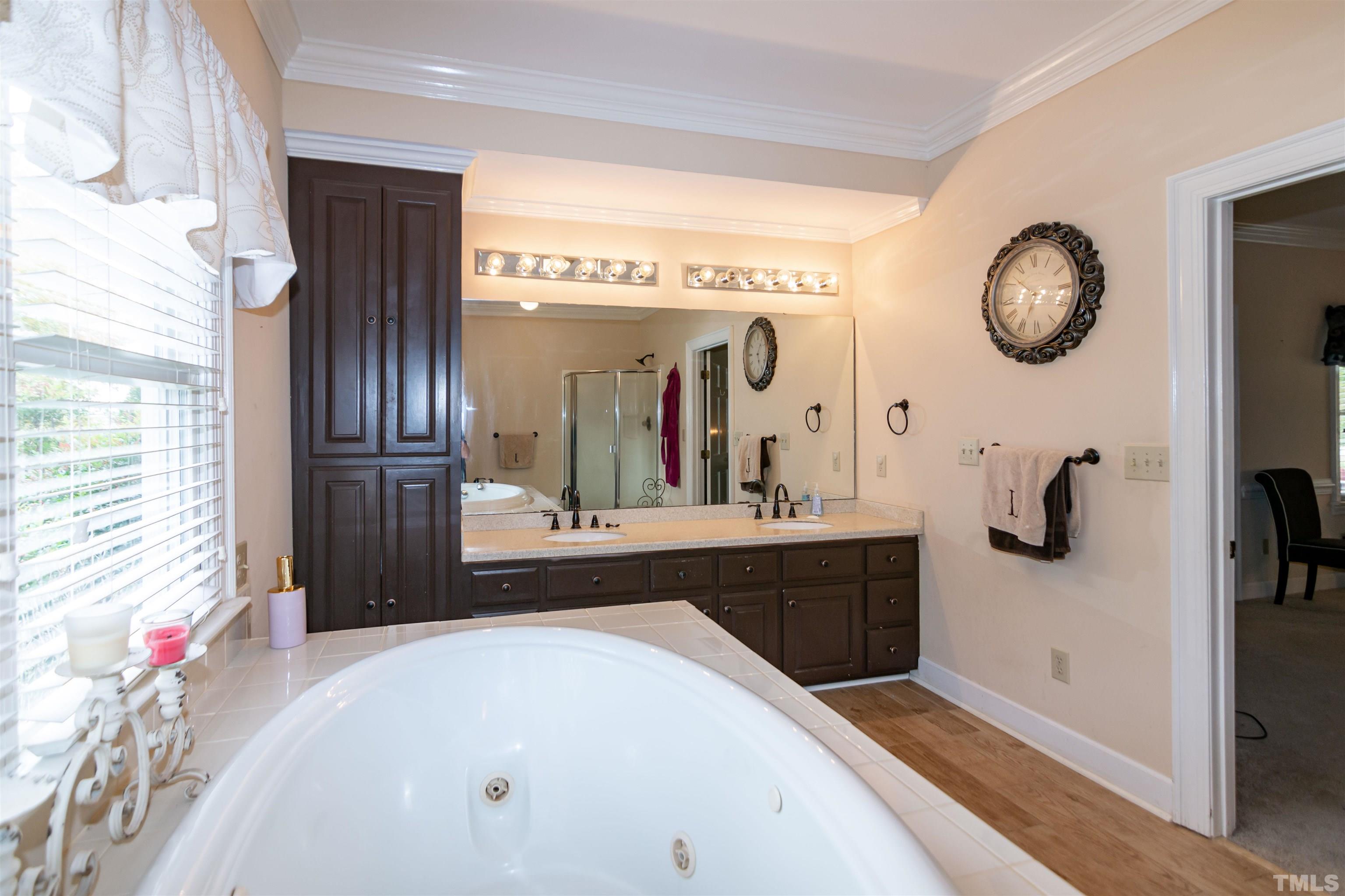 7020 Zebulon Road Wake Forest, NC 27587 - Photo 18 of 45 a spacious bathroom with a double vanity sink and a mirror