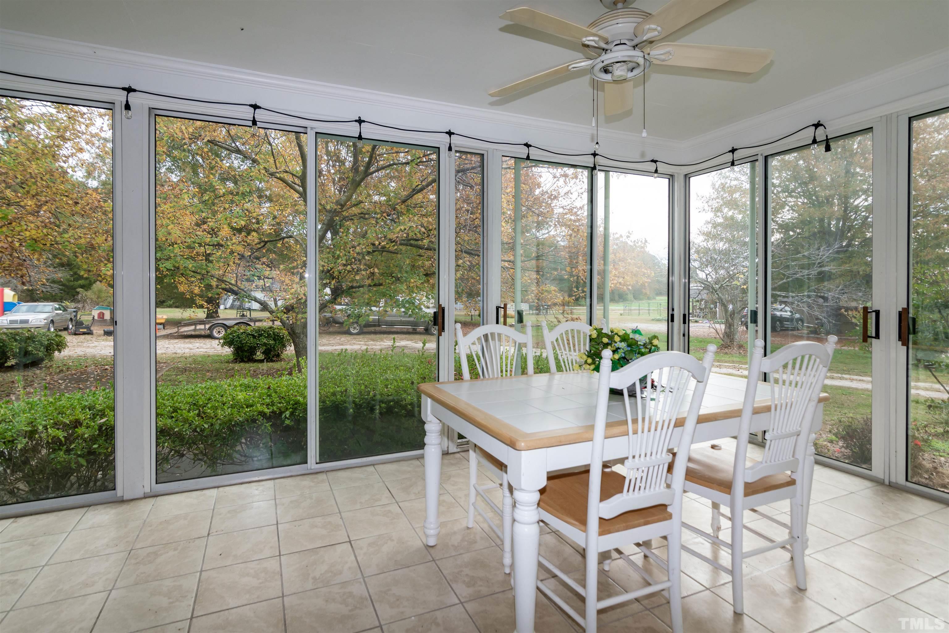 7020 Zebulon Road Wake Forest, NC 27587 - Photo 21 of 45 a dining room with glass windows and outdoor view