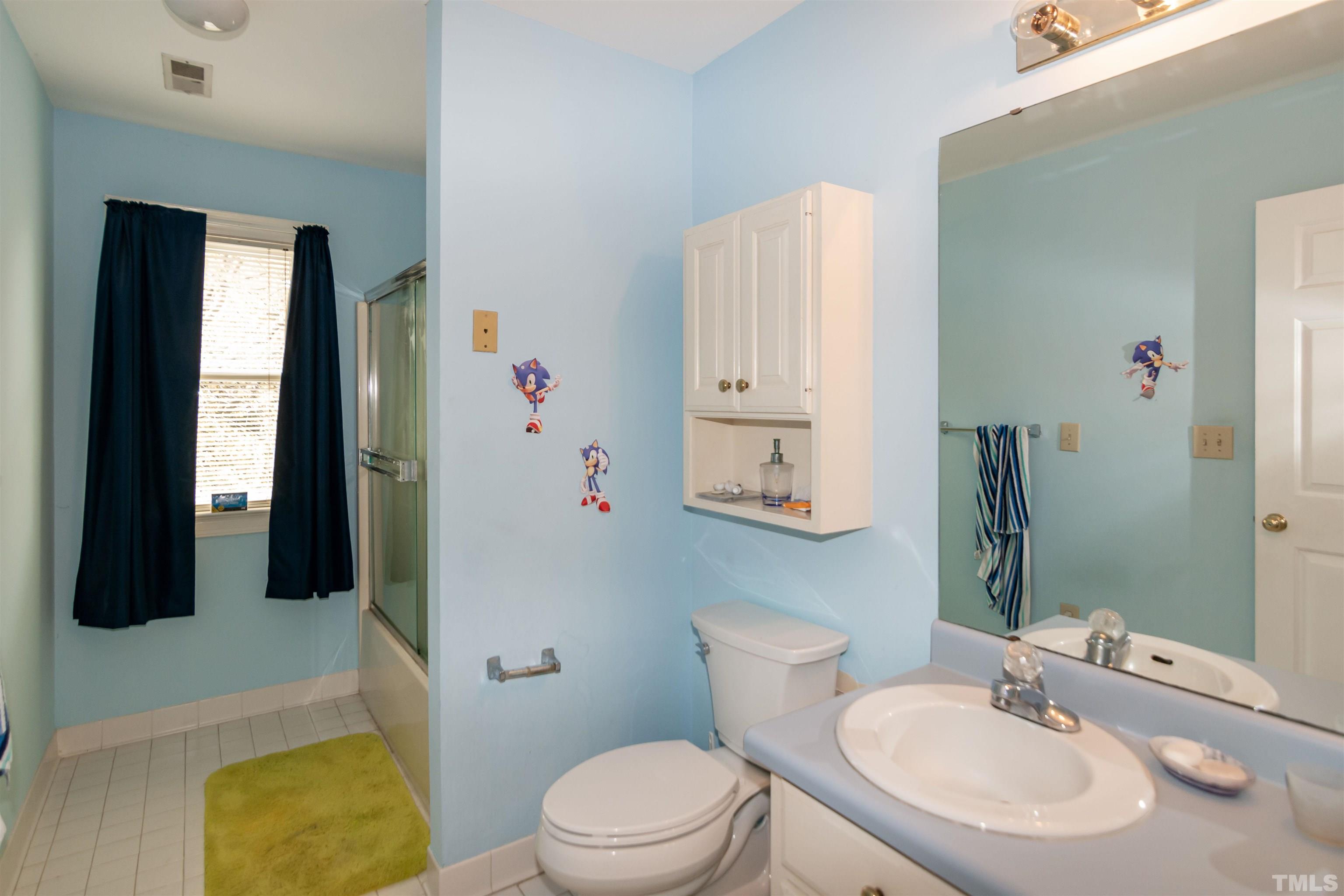 7020 Zebulon Road Wake Forest, NC 27587 - Photo 33 of 45 a bathroom with a sink a toilet and shower curtain