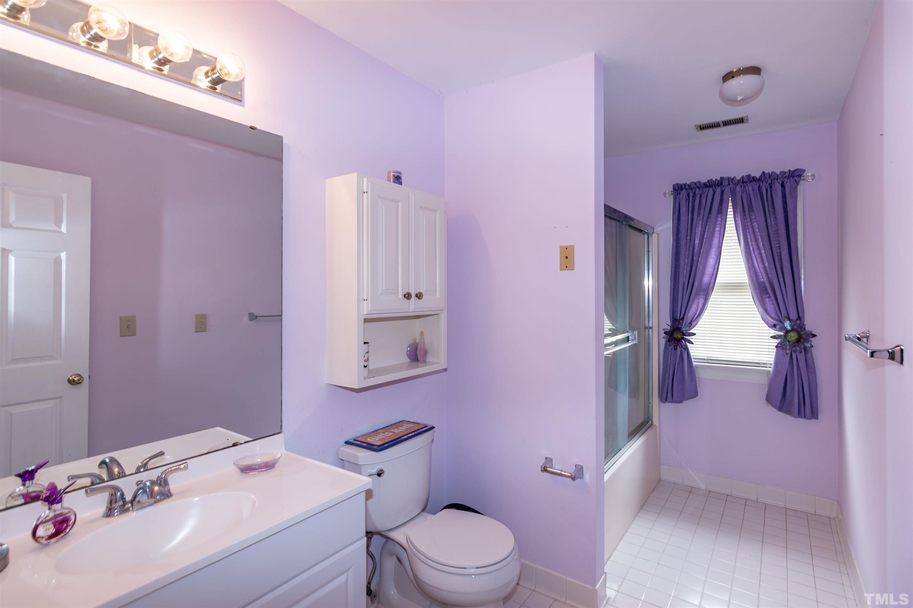 7020 Zebulon Road Wake Forest, NC 27587 - Photo 34 of 45 a bathroom with a sink vanity mirror and toilet