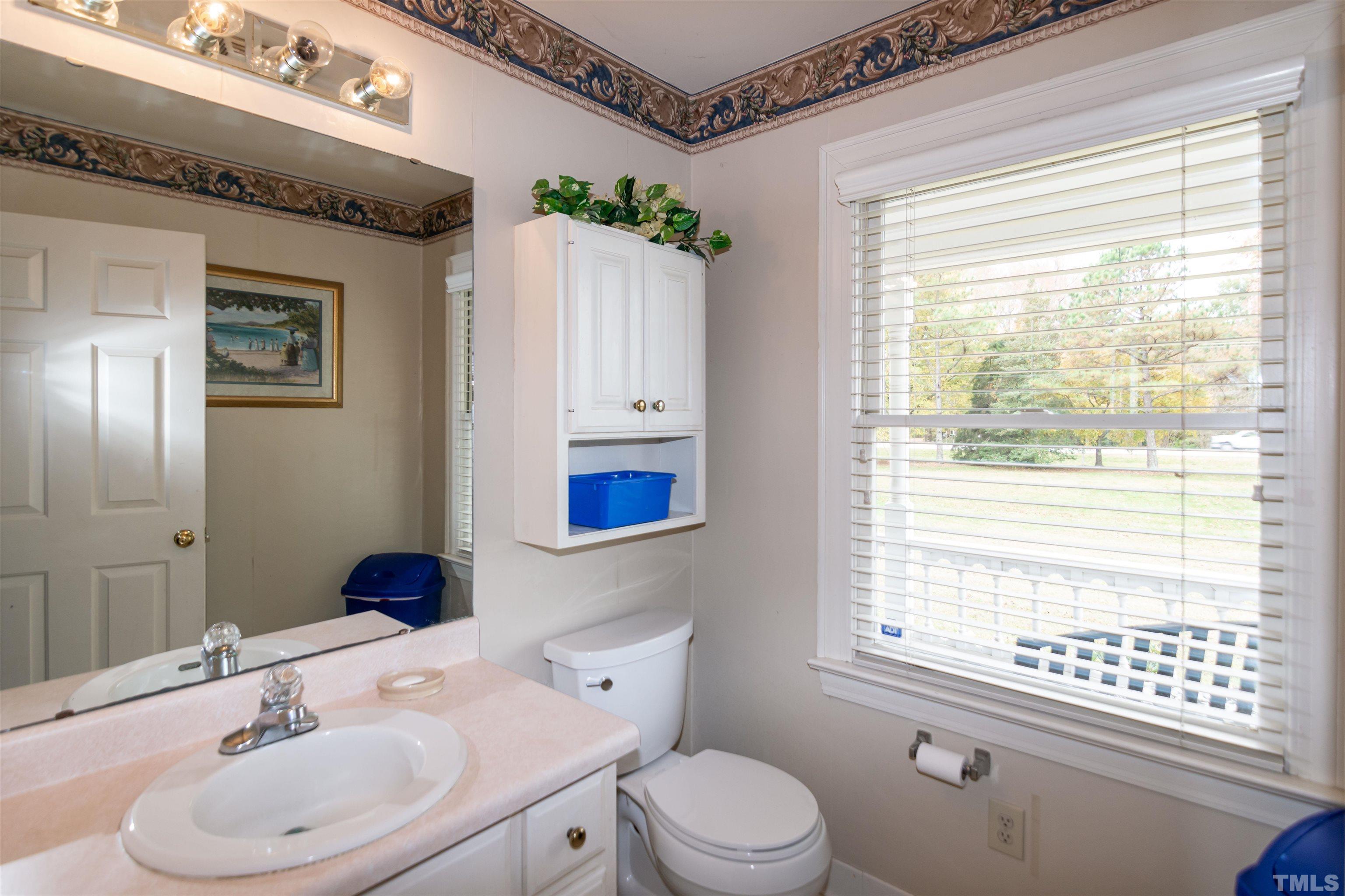 7020 Zebulon Road Wake Forest, NC 27587 - Photo 38 of 45 a bathroom with a sink a toilet and shower