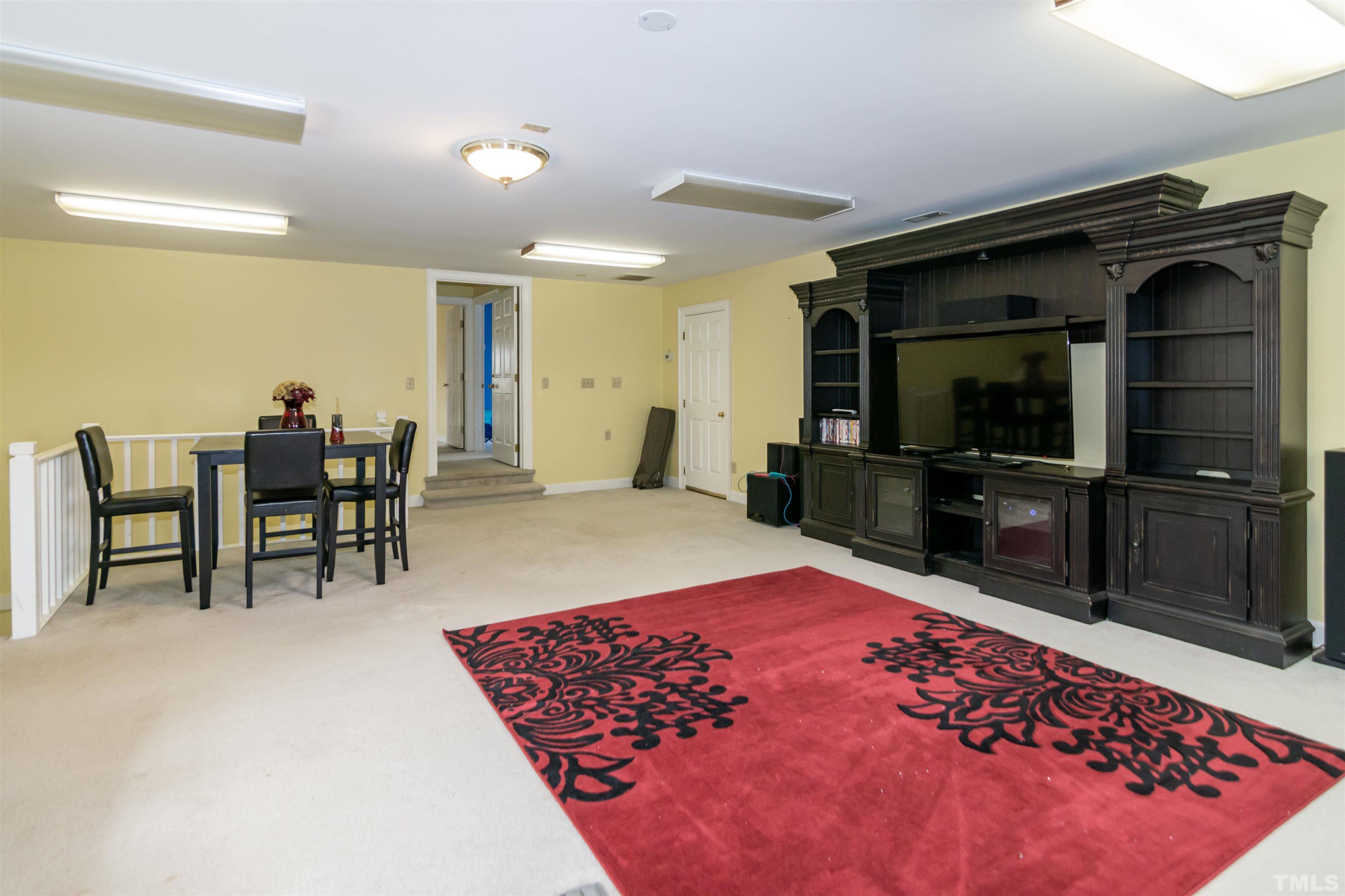7020 Zebulon Road Wake Forest, NC 27587 - Photo 41 of 45 a living room with a rug and a television