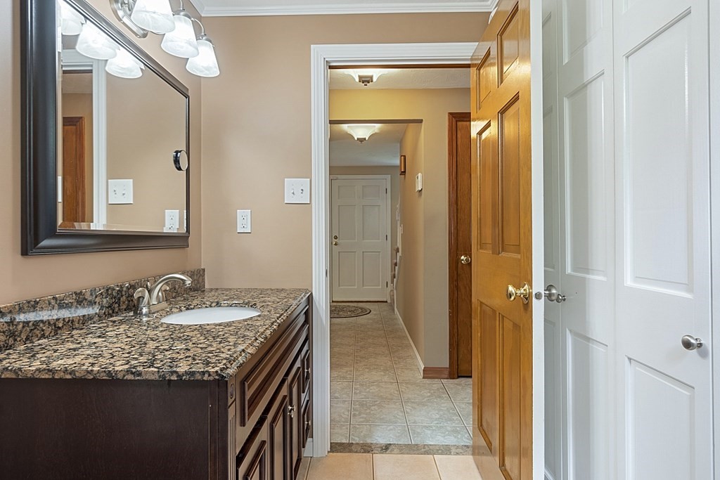 2 Groton Road Tyngsborough, MA 01879 - Photo 15 of 39 a bathroom with a granite countertop sink and a mirror