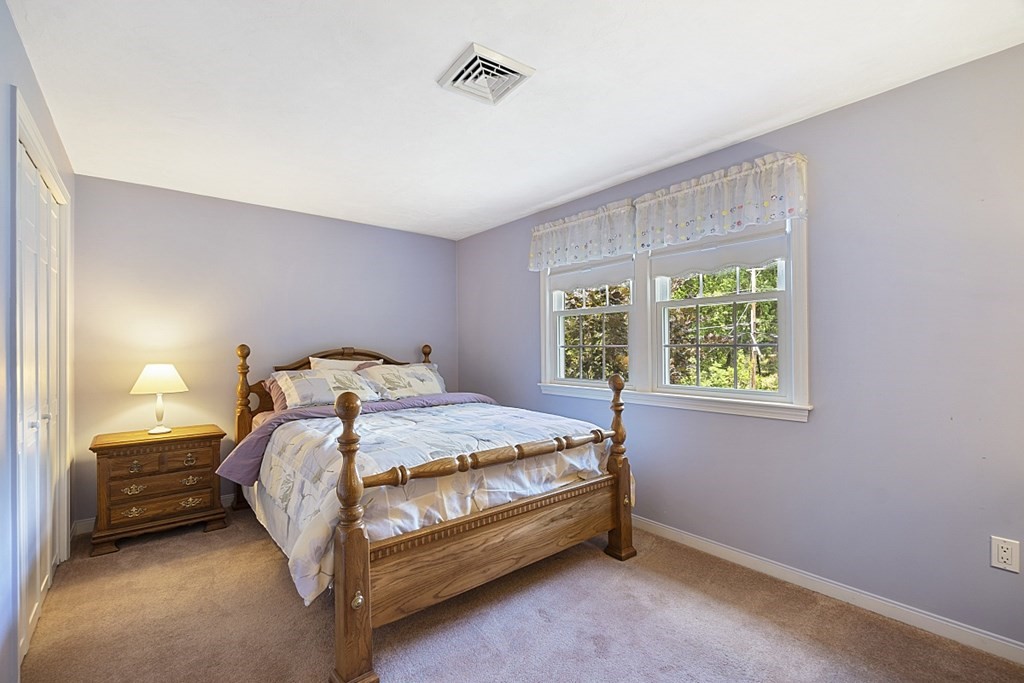 2 Groton Road Tyngsborough, MA 01879 - Photo 20 of 39 a bed sitting in a bedroom next to a window