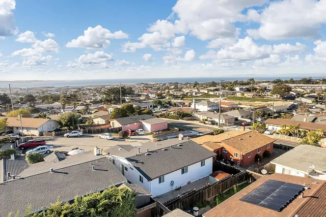 a aerial view of a house with garden space and a car park