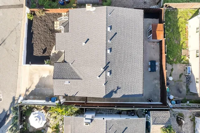 an aerial view of a house with outdoor space