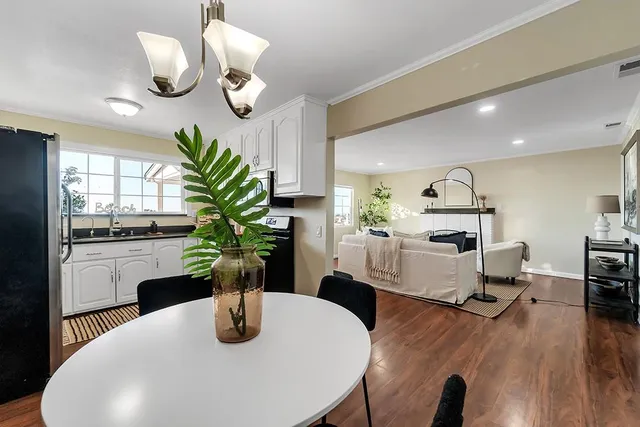 a dining room with furniture and wooden floor