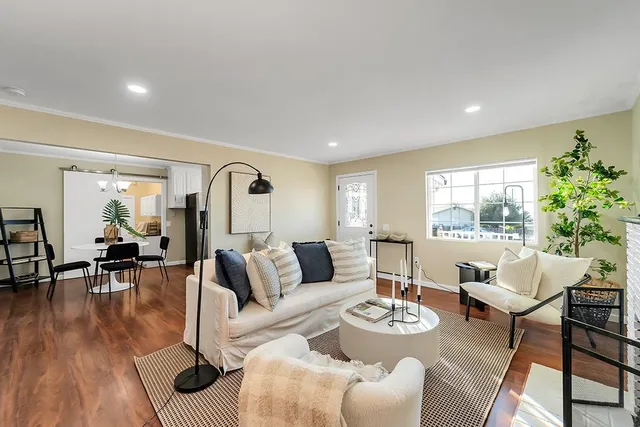 a living room with furniture and wooden floor