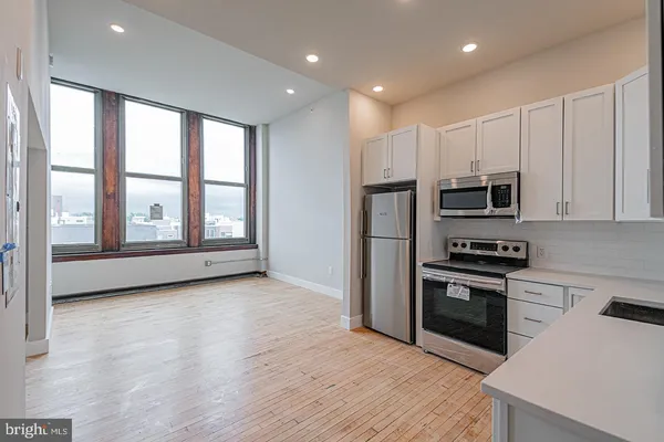a view of kitchen with microwave and stove