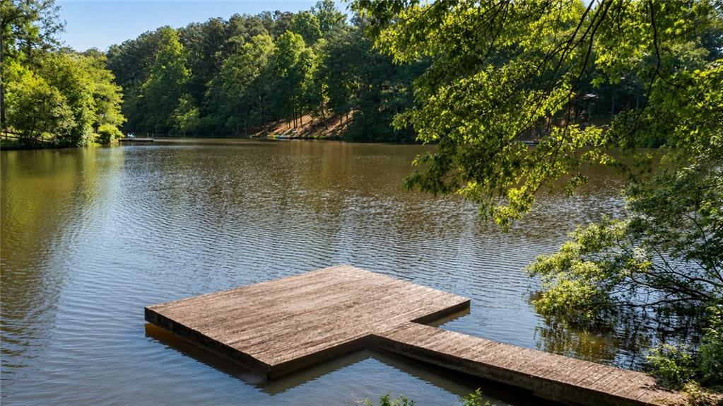 24 Commerce Row Northeast Cartersville, GA 30121 - Photo 5 of 37 a wooden bench sitting next to a lake