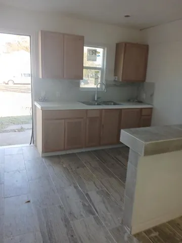 a kitchen with granite countertop a sink and a stove
