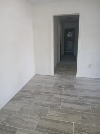 a view of hallway with wooden floor