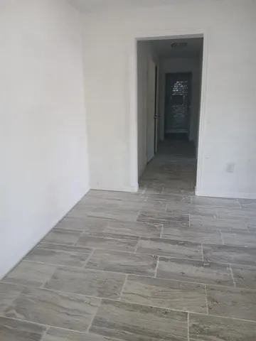 a view of hallway with wooden floor
