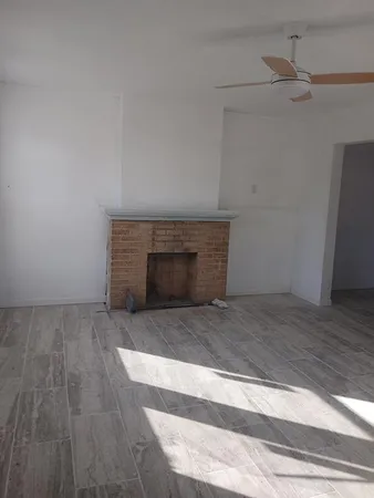 a room with a fireplace and cabinet