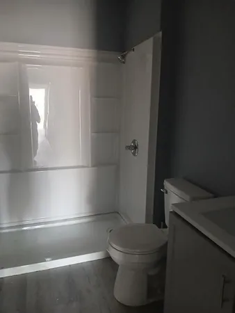 a bathroom with a toilet and a shower