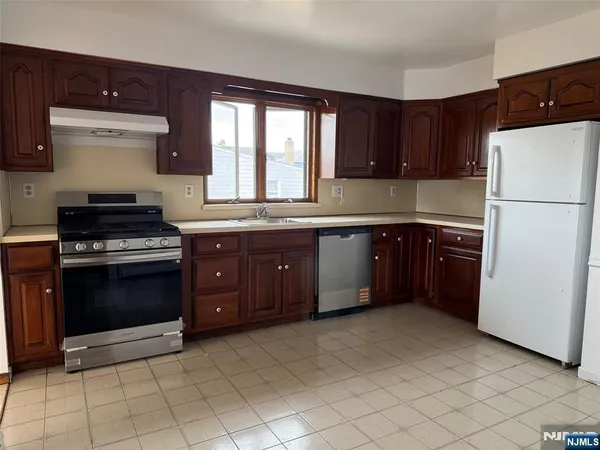 a kitchen with a sink a stove and refrigerator