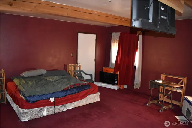 a bed sitting in a room next to a window