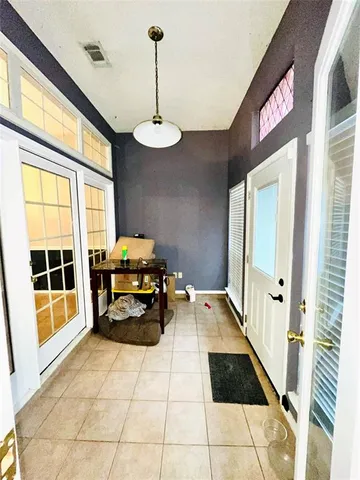 a hallway with furniture and a chandelier