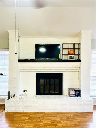 a living room with stainless steel appliances with kitchen view