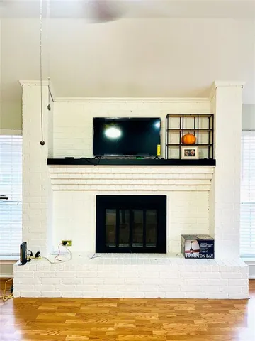 a living room with stainless steel appliances with kitchen view