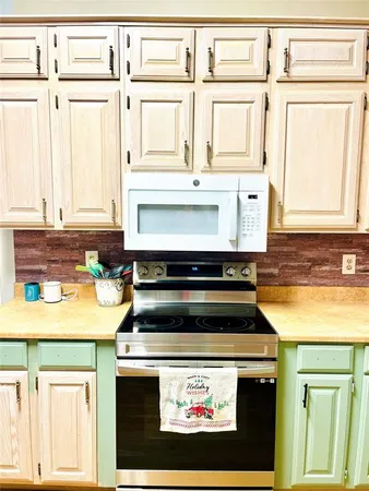a stove top oven sitting inside of a kitchen