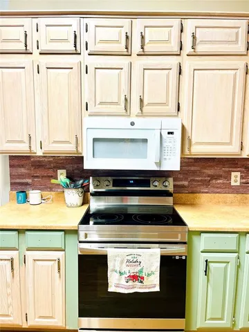 a stove top oven sitting inside of a kitchen