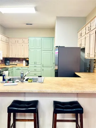 a kitchen with a sink cabinets and a table
