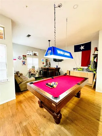 a room with pool table and flat screen tv