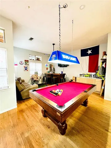 a room with pool table and flat screen tv
