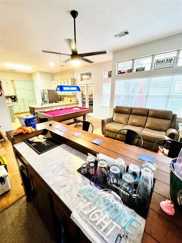 a room with furniture and a view of kitchen