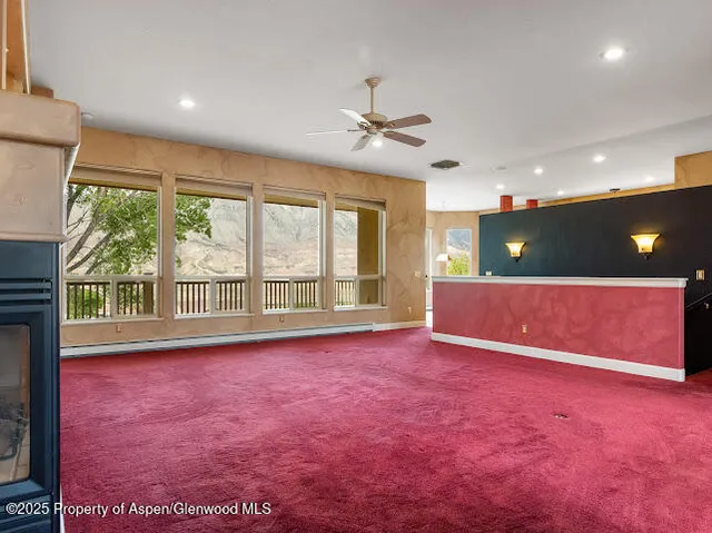 a view of a dining room with furniture large windows and wooden floor