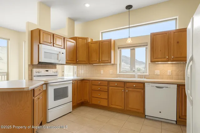 a bathroom with a sink a toilet a window and bathtub