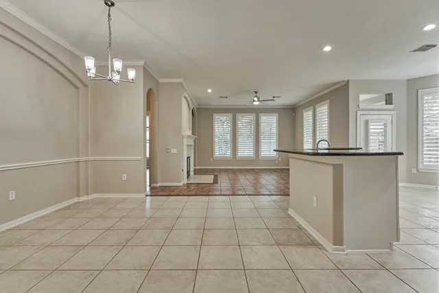 a view of a kitchen with a sink and chandelier