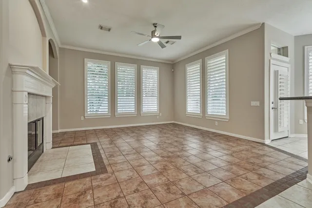 a view of empty room with fireplace and fan