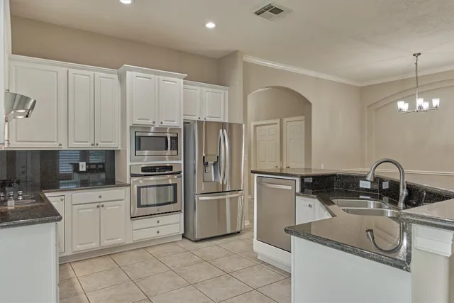 a kitchen with stainless steel appliances a sink and a refrigerator