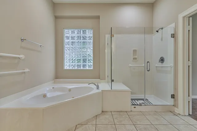 a white bath tub sitting next to a shower
