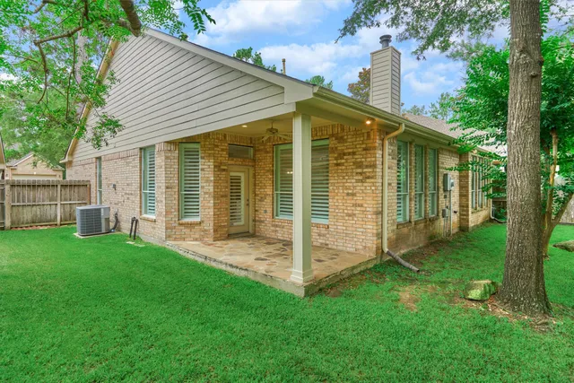 a view of a backyard with a door and the trees