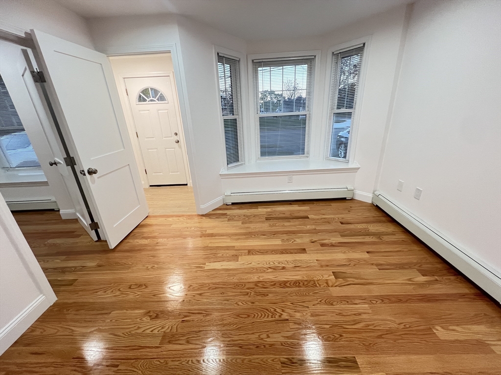 50 Conant Street, Unit 50 Danvers, MA 01923 - Photo 2 of 16 a view of an empty room with wooden floor and a window