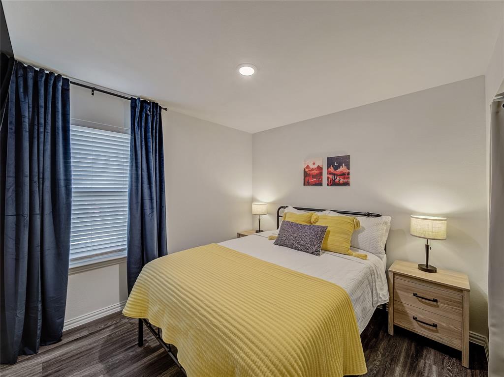 921 West 9th Street Bonham, TX 75418 - Photo 12 of 22 2nd Bedroom featuring dark wood-type flooring and baseboards