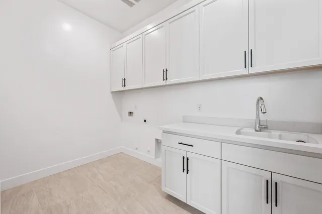 a kitchen with white cabinets and a sink