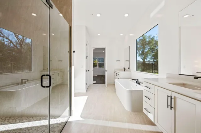 a bathroom with a granite countertop sink mirror and bathtub