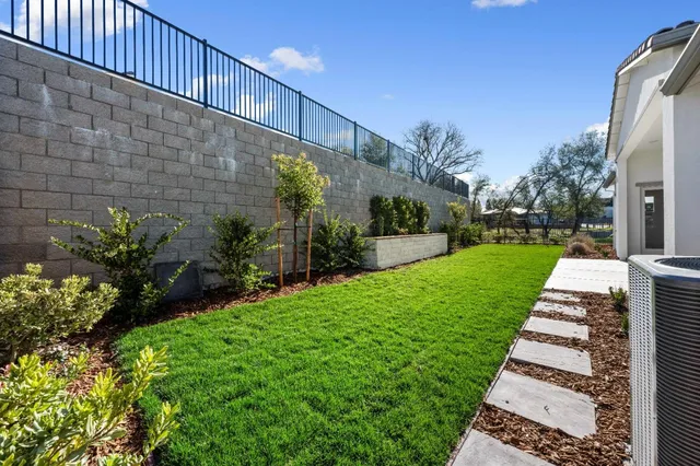 a view of a pathway with a garden