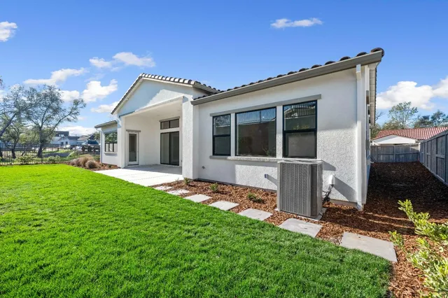 a view of a house with yard and a garden