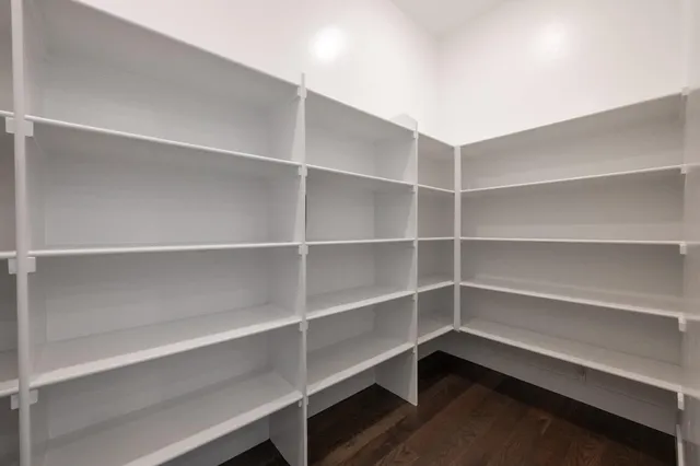 a view of walk in closet with empty racks
