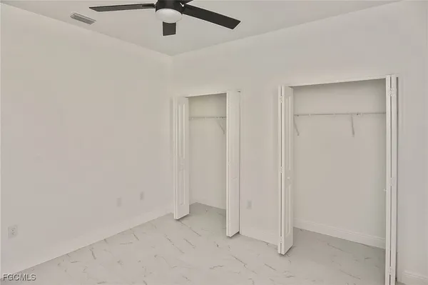 an empty room with a ceiling fan