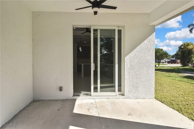 a view of a porch with a table and chairs