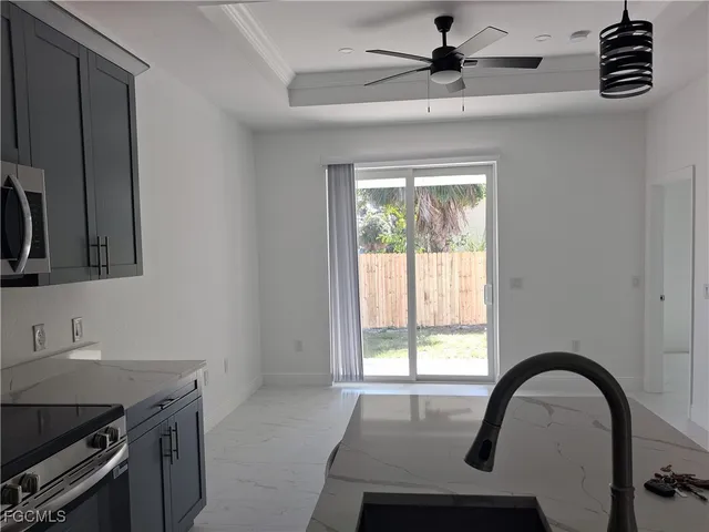 a view of a kitchen with a sink and chandelier