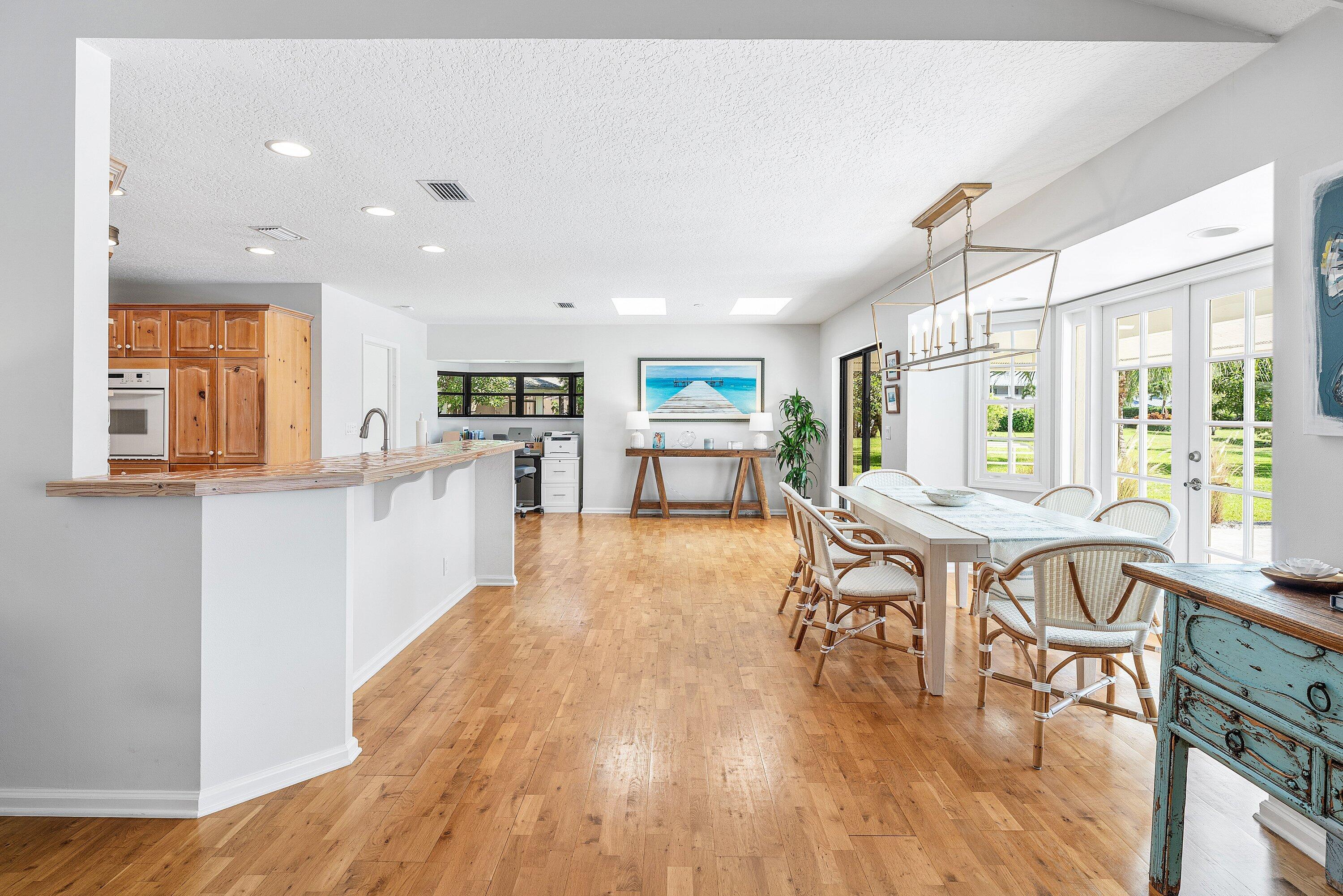 6048 Wood Lake Road Jupiter, FL 33458 - Photo 11 of 31 a view of a dining room with furniture window and wooden floor
