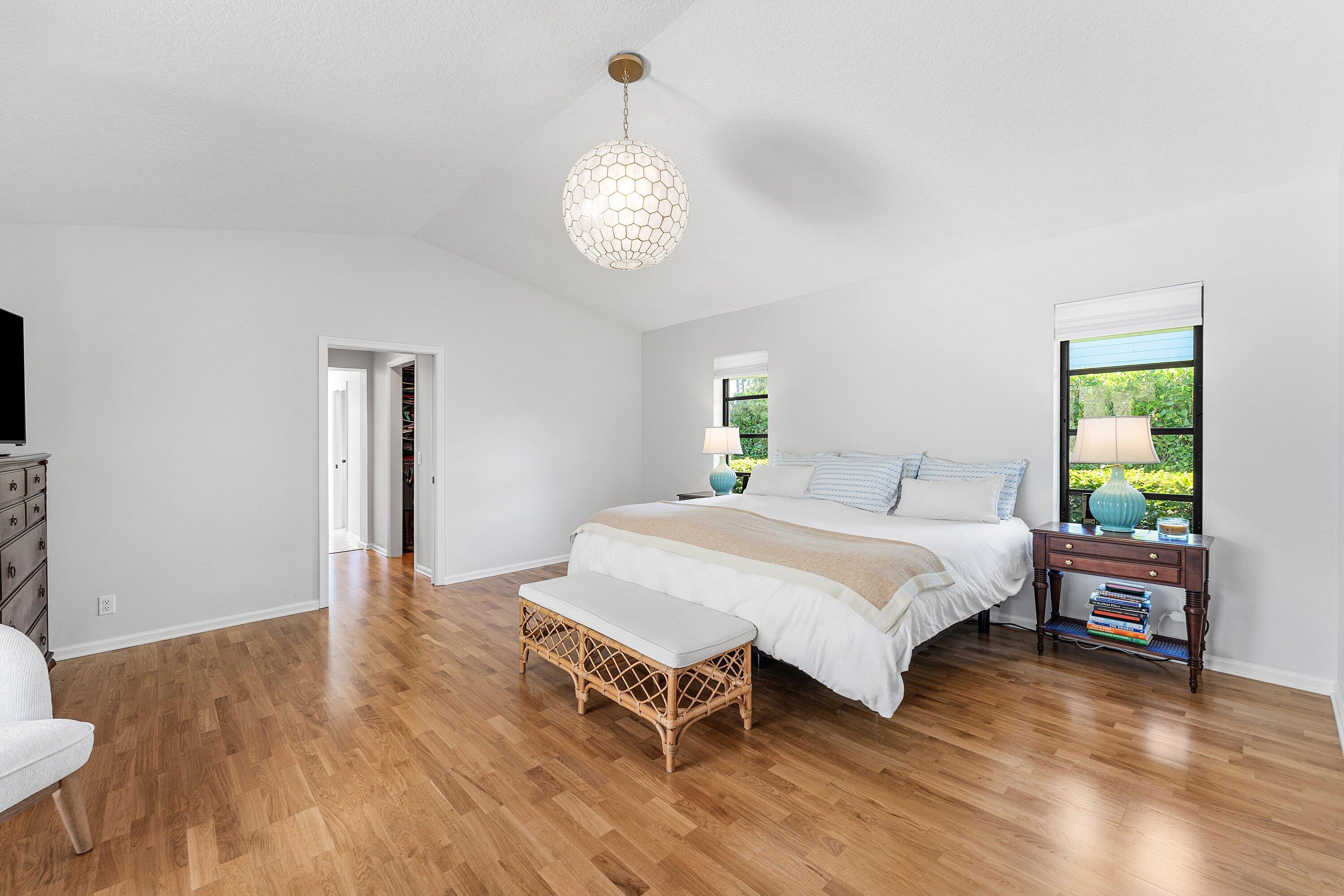 6048 Wood Lake Road Jupiter, FL 33458 - Photo 12 of 31 a spacious bedroom with a bed and a table in it