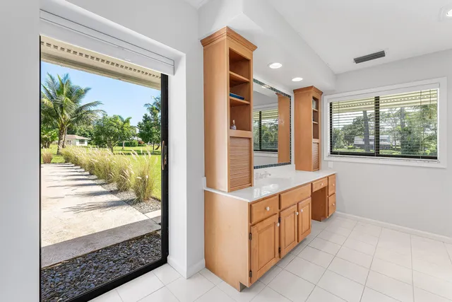 a kitchen with granite countertop a stove and a wooden floor
